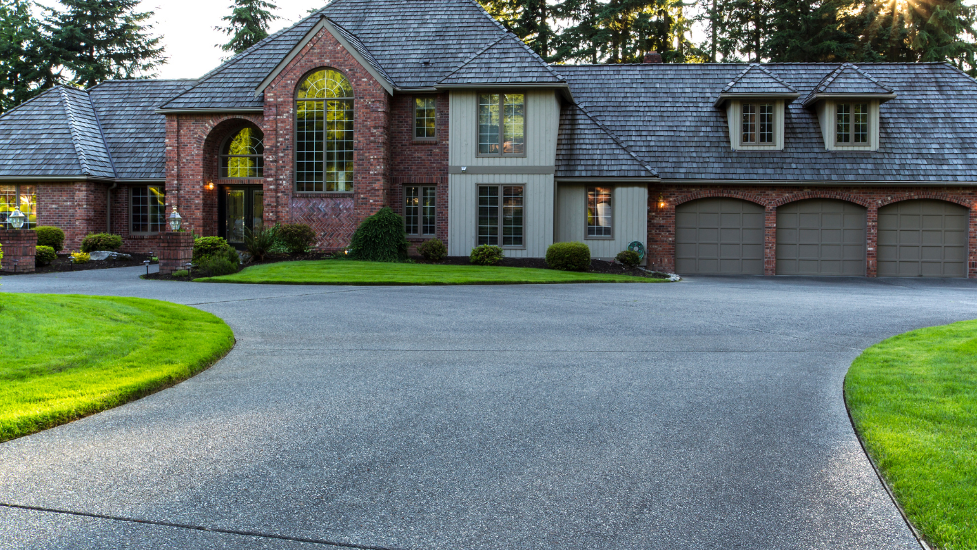 A large brick house with a driveway leading to it