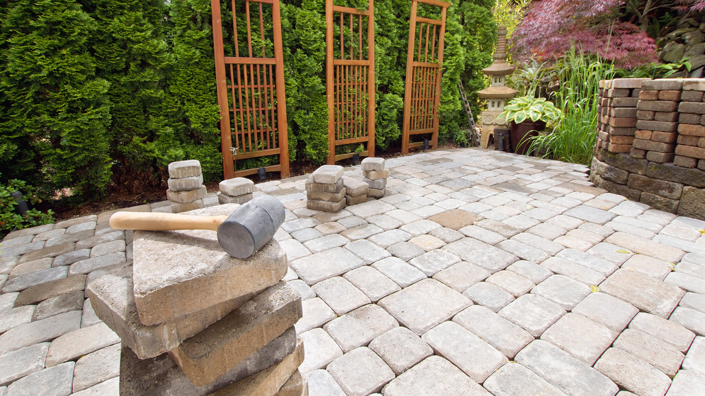 A brick patio with a baseball bat on top of it